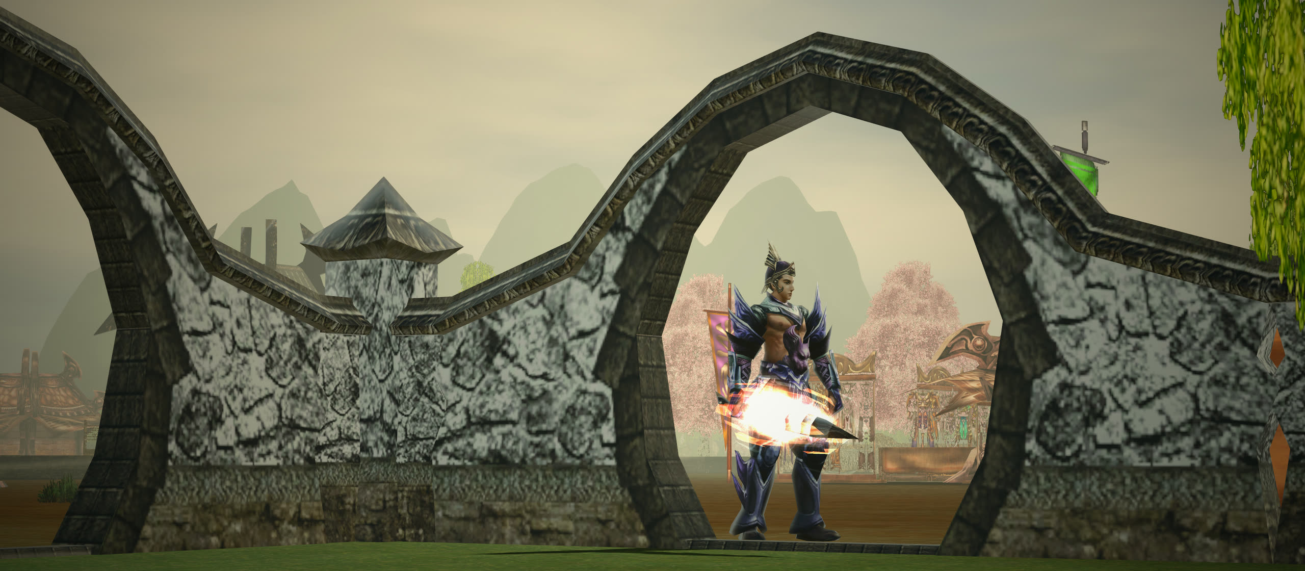 In-game photo: a swordsman in dark blue armour stands in a round moon gate of the Xiah Prairie village wall, blossom trees and market stalls behind him under a cloudy sky
